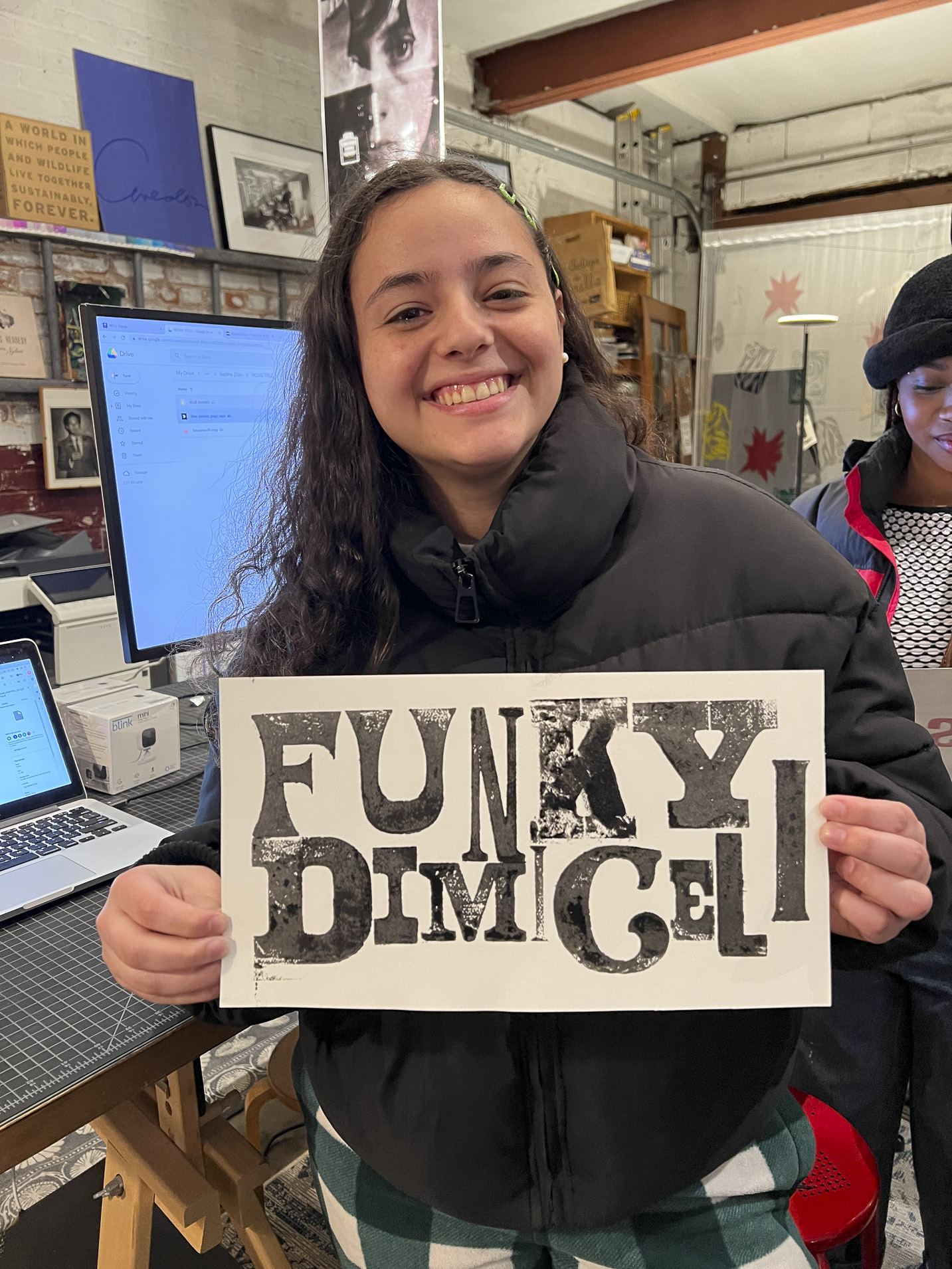 Tisch student holding a print made with hand-set type